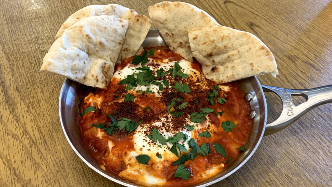 Delicious Shakshuka - Eggs poached in a spicy stewed tomato sauce - Ben ...